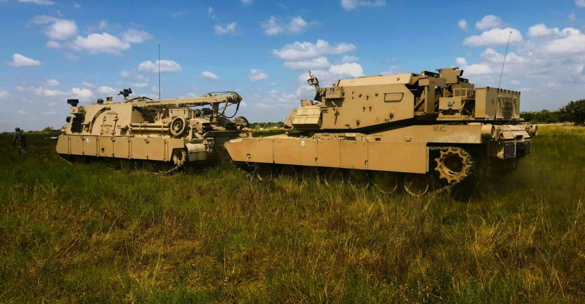A couple of tanks that are sitting in the grass
