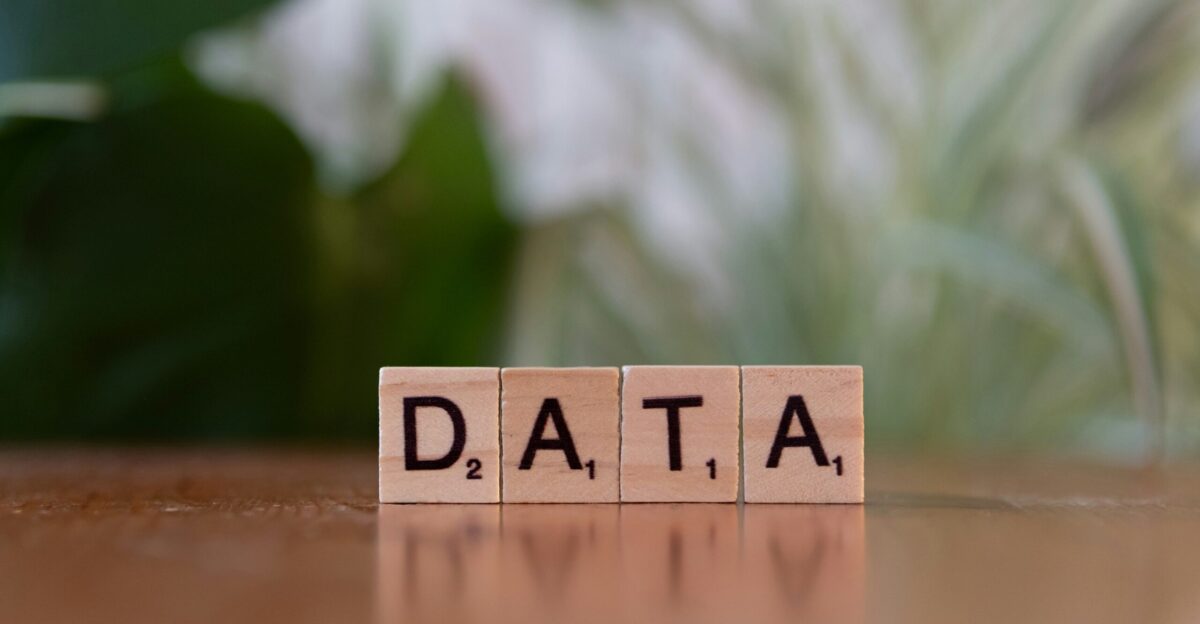 A wooden block spelling data on a table