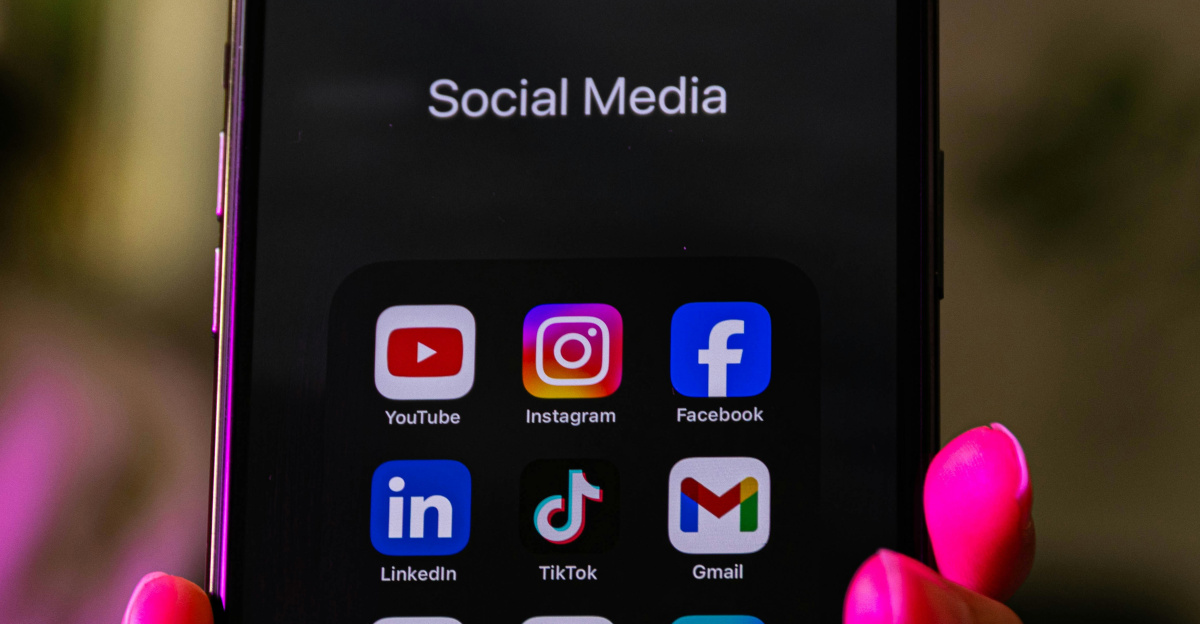 A smartphone displays social media app icons.