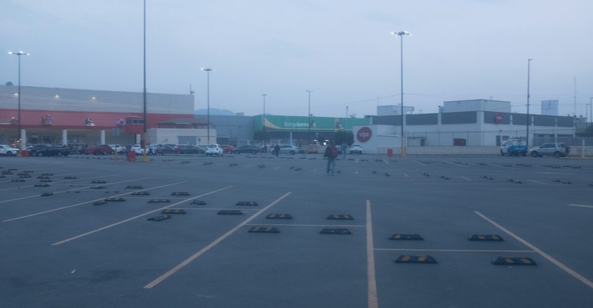 Empty parking lot with buildings in the background