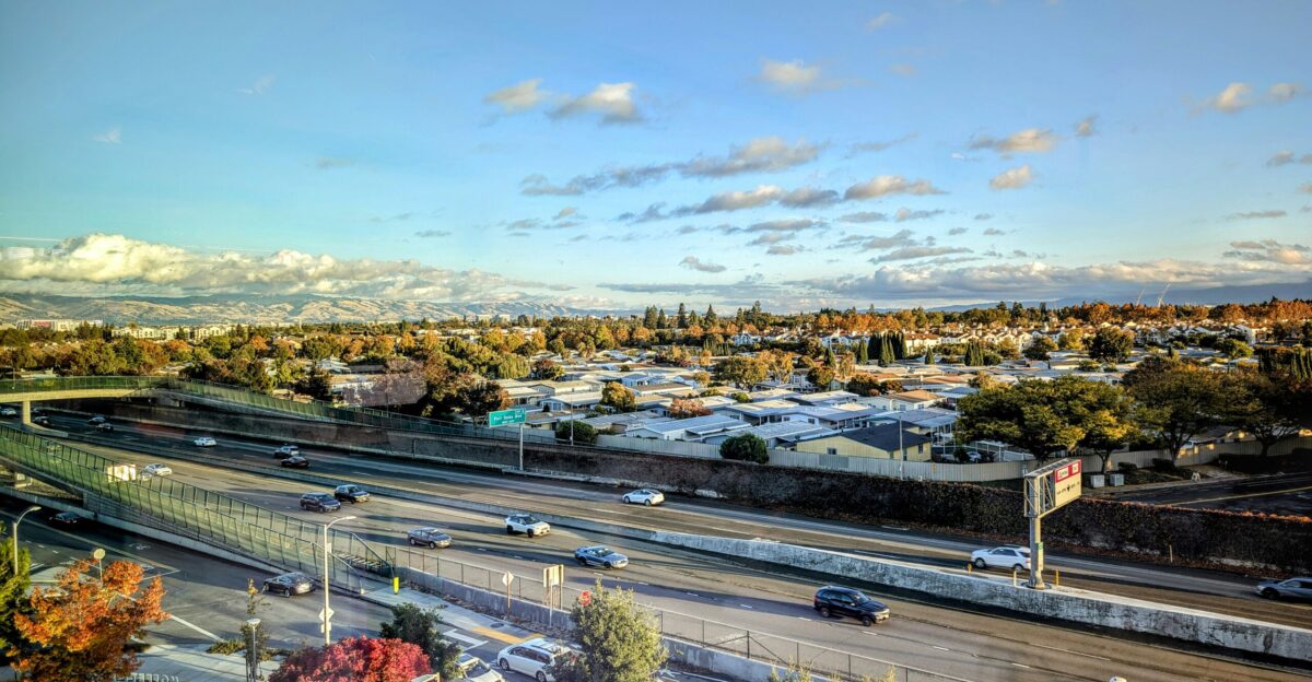 A highway runs through a suburban cityscape