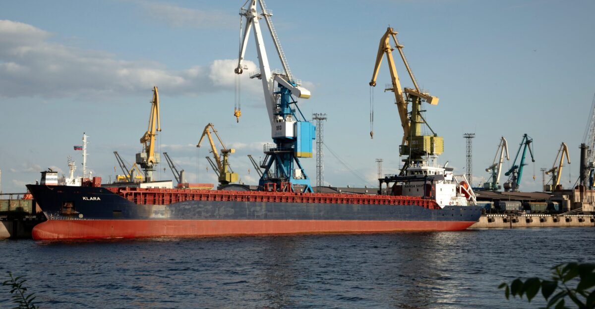 A cargo ship docks at a busy port