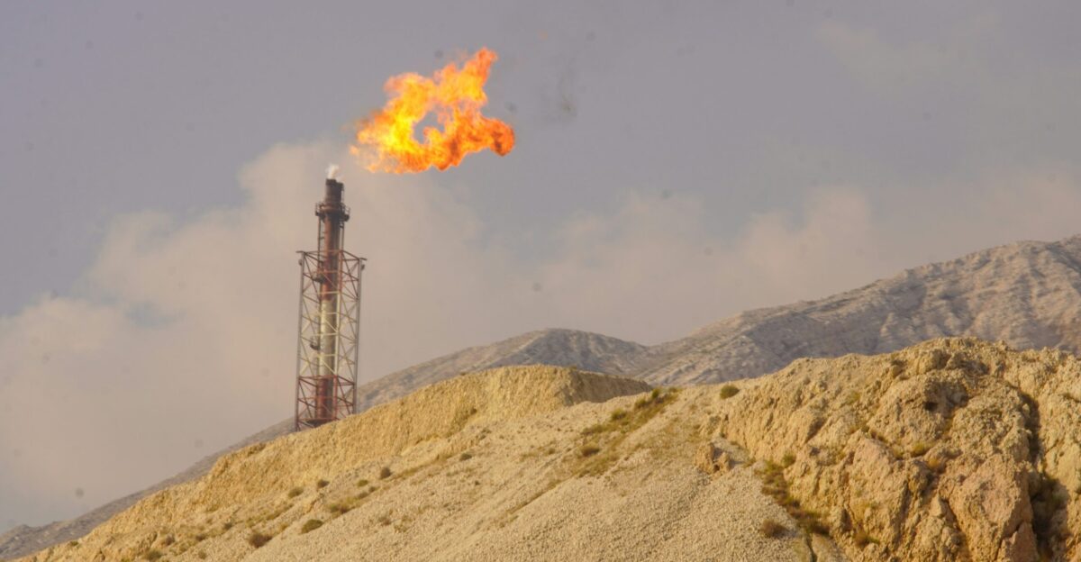 A flare burns brightly from a tower