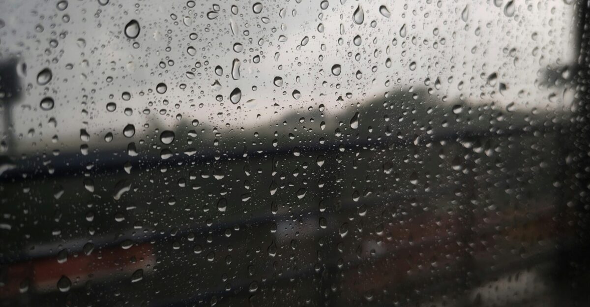 Raindrops on a window with blurred background