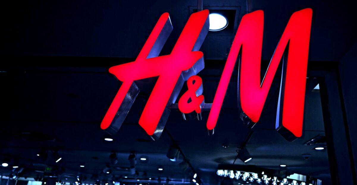 Red h m logo illuminated at night
