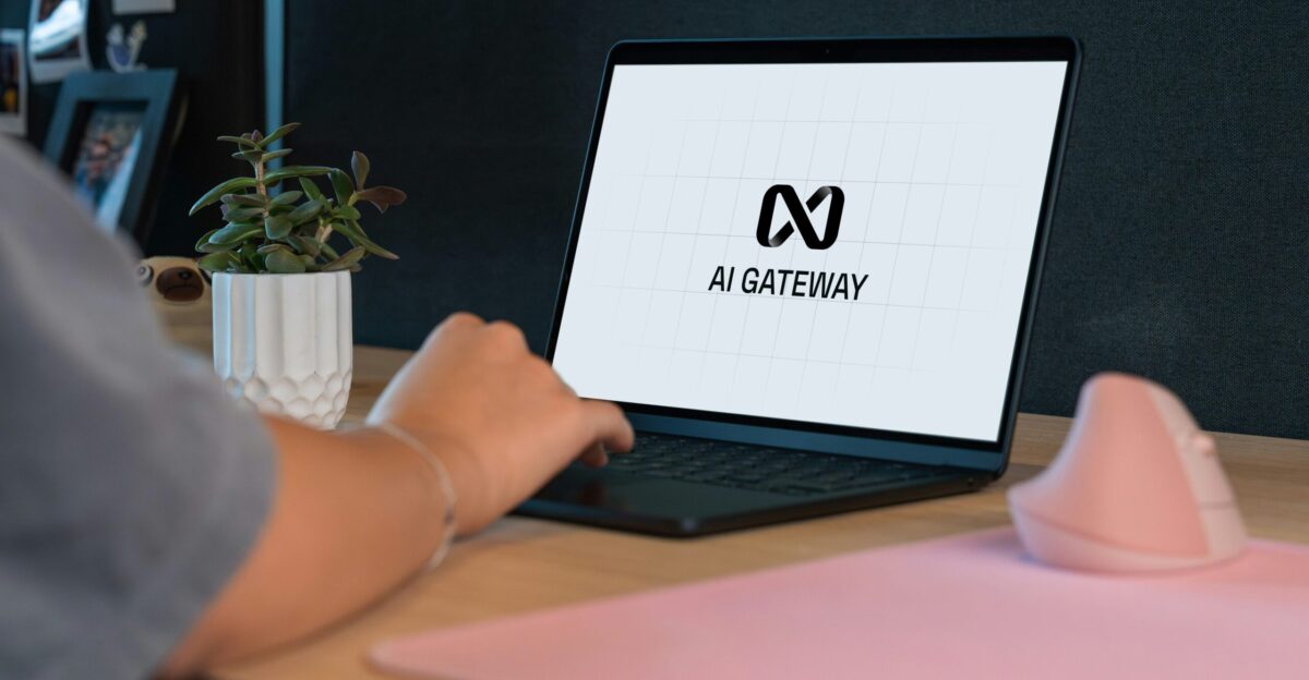 Person typing on laptop with ai gateway logo