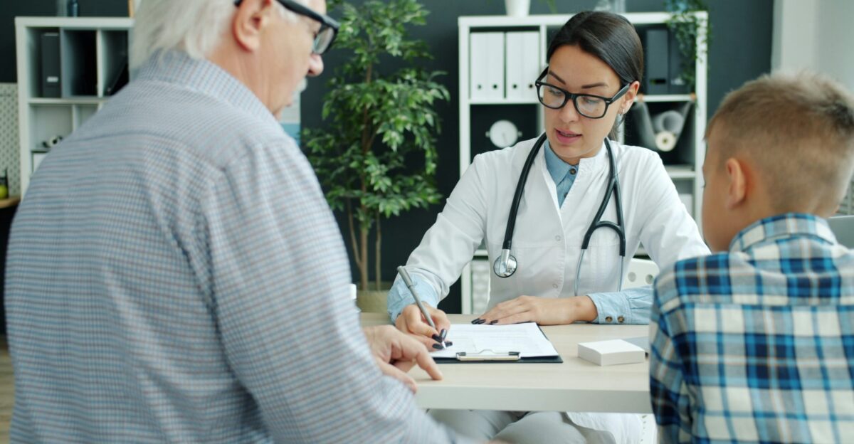 Doctor consulting with elderly man and child