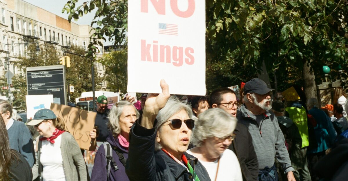People protest with a no kings sign