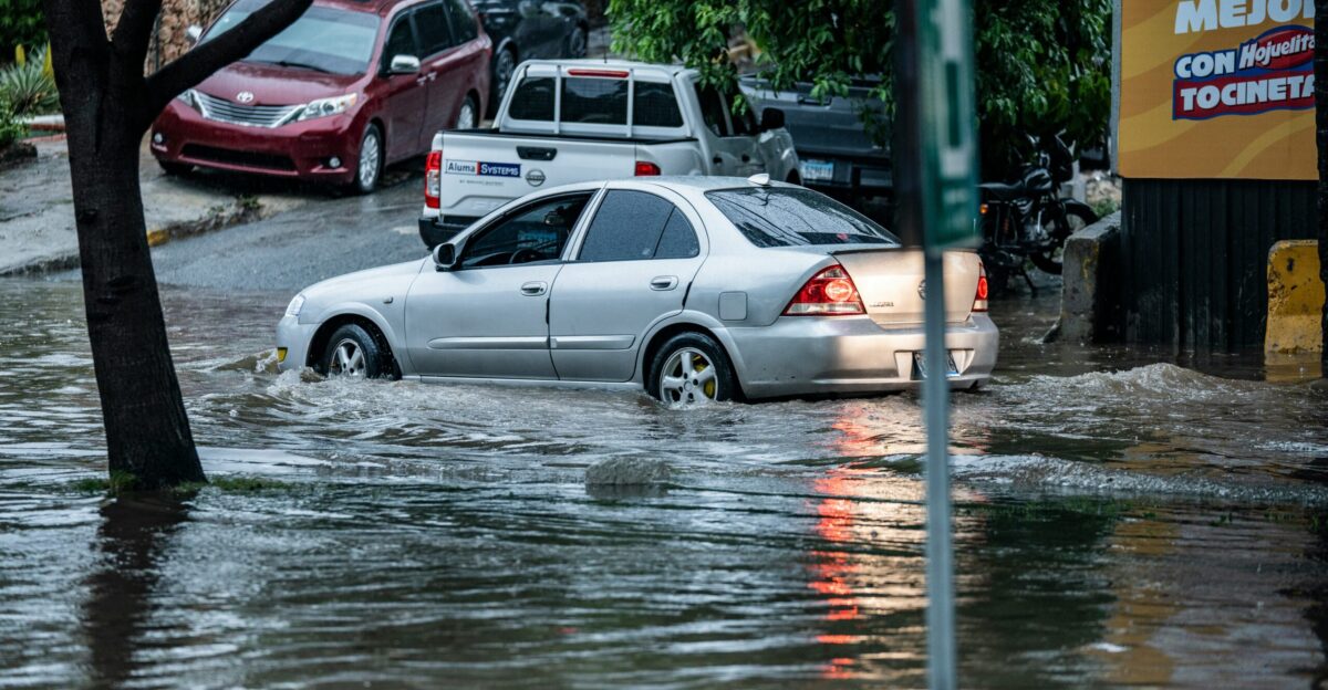 Cars driving through flooded street after heavy rain