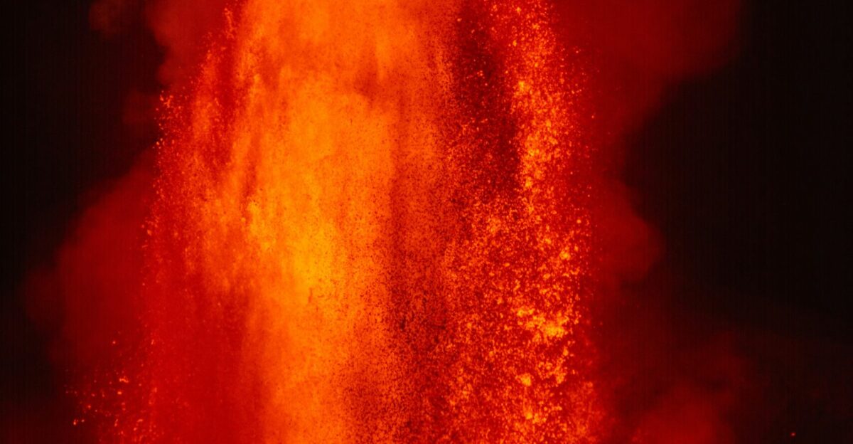 Volcano erupting with molten lava and smoke