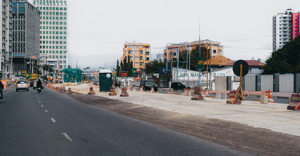 City street with buildings and construction site.