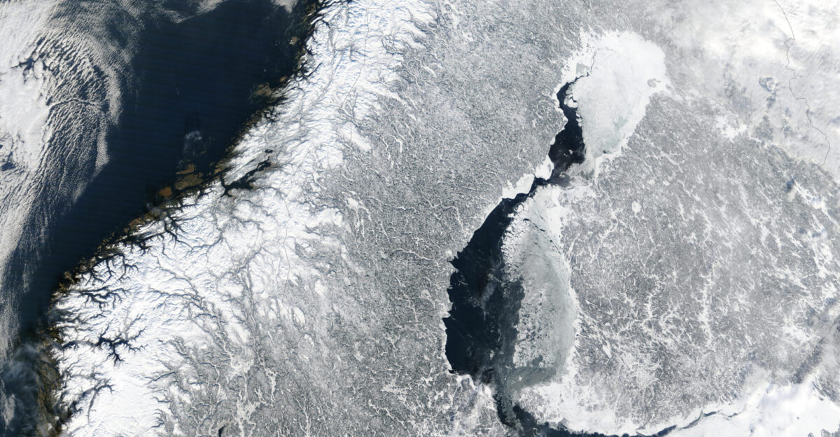 Scandinavia from space in winter The Moderate Resolution Imaging Spectroradiometer MODIS instrument aboard NASA s Terra satellite captured the above image of the Scandinavian Peninsula on February 19 2003 With a landscape largely shaped by glaciers over the last ice age the Scandinavian Peninsula is as picturesque in the winter as it is cold Along the left side of the peninsula one can see the jagged inlets known as fjords lining Norway s coast Many of these fjords are well over 2 000 feet 610 meters deep and were carved out by extremely heavy thick glaciers that formed during the last ice age The glaciers ran off the mountains and scoured troughs into Norway s coastline with depths that reached well below sea level When the glaciers melted the seawater rushed into these deep troughs to form the fjords The deepest fjord on Norway s coast known as Sogn Fjord lies in southwest Norway and is 4 291 feet 1 308 m deep Glaciers also carved the mountains in Norway and northernmost Sweden South of this mountainous region however Sweden consists mostly of flat heavily forested land dotted with lakes Lake V nern and Lake V ttern the largest of Sweden s lakes do not freeze completely during the winter months and can be seen clearly at the bottom of the peninsula Lake V ttern the smaller of the two lakes was connected to the Baltic Sea during the last ice age After the ice melted a tremendous weight was lifted off of the peninsula and the landmass rose up to separate the lake from the Baltic Sea To the northeast of the peninsula lies Finland with more than 55 000 lakes most of which were also created by glacial deposits