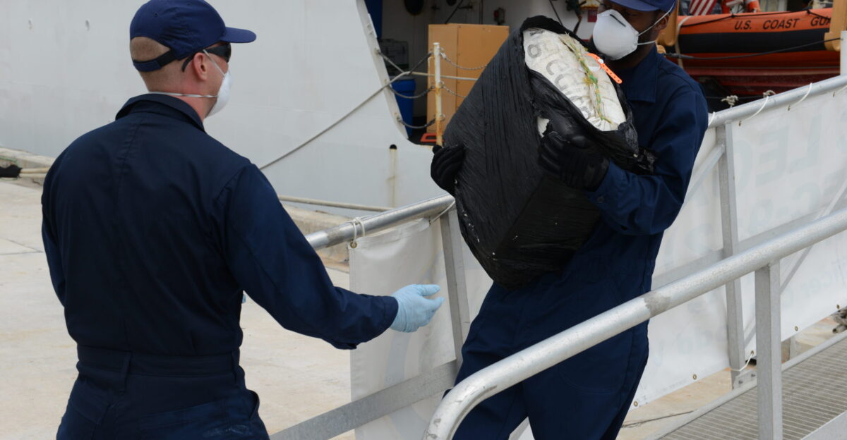 Crew members aboard the Coast Guard Cutter Legare offload bales on cocaine during a contraband offload at Coast Guard Base Miami Beach Fla Sept 4 2014 These interdictions were part of Operation Martillo which is one component in the United States government s whole-of-government approach to countering the use of the Central American littorals as transshipment routes for illicit drugs weapons and cash U S Coast Guard photo by Petty Officer 3rd Class Mark Barney VIRIN 140904-G-ZK759-042