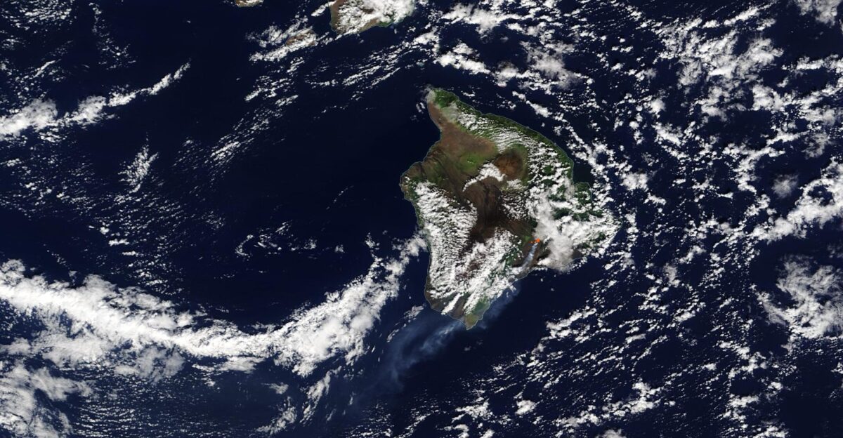 After several weeks of steadily increasing seismic rumbling and ground deformation Kilauea Volcano began a dramatic eruption on December 20 According to the Hawaiian Volcano Observatory HVO observation cameras detected a glow within Halema uma u Crater at the summit of Kilauea at 9 30 p m Hawaiian Standard Time 2 00 p m EST indicating an eruption had begun Three fissures subsequently opened in the walls of Halema uma u Crater releasing flowing lava As the lava interacted with the lake at the summit of Kilauea a large plume of steam rose over the volcano Once the water had boiled away lava began to pond in the lake Fountains of lava reached as high as 50 meters 164 feet The Moderate Resolution Imaging Spectroradiometer MODIS on board NASA s Terra satellite acquired a true-color image of the eruption on December 21 A red hot spot can be seen at the edge of cloud on Kilauea s summit marking the location where the thermal bands on the MODIS instrument detected high temperatures caused by lava A plume of volcanic ash water vapor and sulfur dioxide gas streams towards the southwest over the ocean As of December 23 the volcano continues active eruption The HVO estimated that the growing crater lake was 143 m 470 feet deep with a surface area of 22 ha 54 acres Sulfur dioxide emission rates are estimated at 30 000 tonnes day 33 069 US tons day Seismicity remains elevated but stable with a few minor earthquakes and tremors related to vigorous fountaining from the fissures Kilauea is the most active and youngest of the Hawaiian shield volcanoes remaining in near-constant eruption The volcano had maintained a low level of non-eruptive unrest since the end of the 2018 eruption and summit collapse which deepened the Halema uma u Crater A lake began to form in the crater in July 2019 Increased rates of uplift were detected by GPS stations beginning in September 2020 and increased earthquake rates began in late November 2020 By December 17 long-period seismic signals beneath the summit increased suggesting magmatic activity According to the HVO it is unclear how long the current eruption will continue Kilauea summit eruptions over the past 200 years have lasted from less than a day to more than a decade
