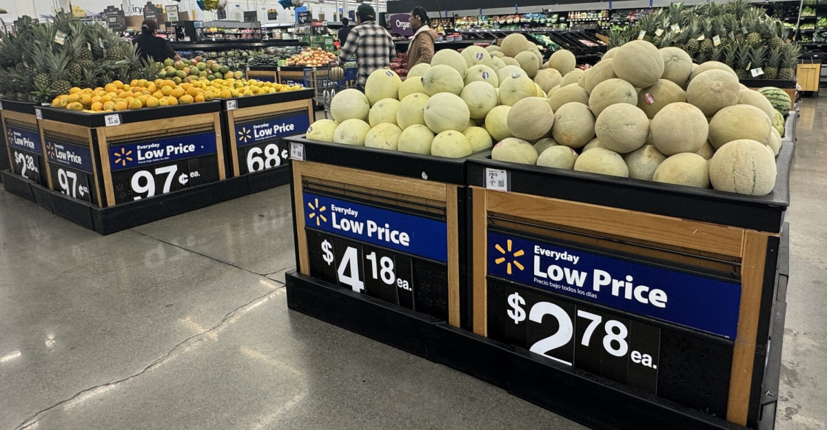 Produce section of a Walmart store with bins of melons, pineapples, and other fruit under “Everyday Low Price” signs. Napa, California.