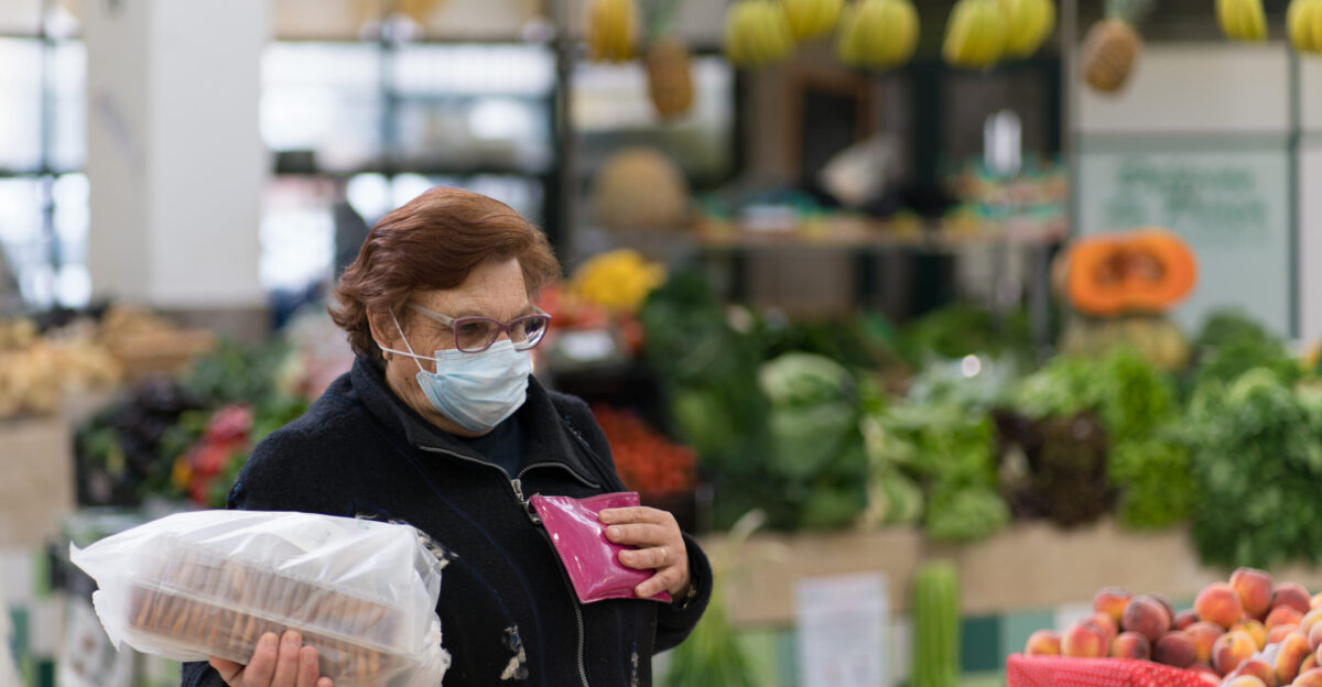 Woman buying groceries during the COVID-19 lockdown Mercado de Arroios Lisbon Portugal