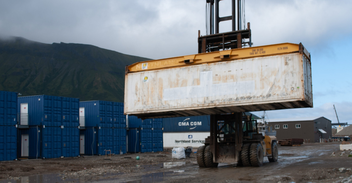 Loader with refrigerated shipping container of frozen fish for export at the Trident Seafoods plant in False Pass, Alaska on September 7, 2018.