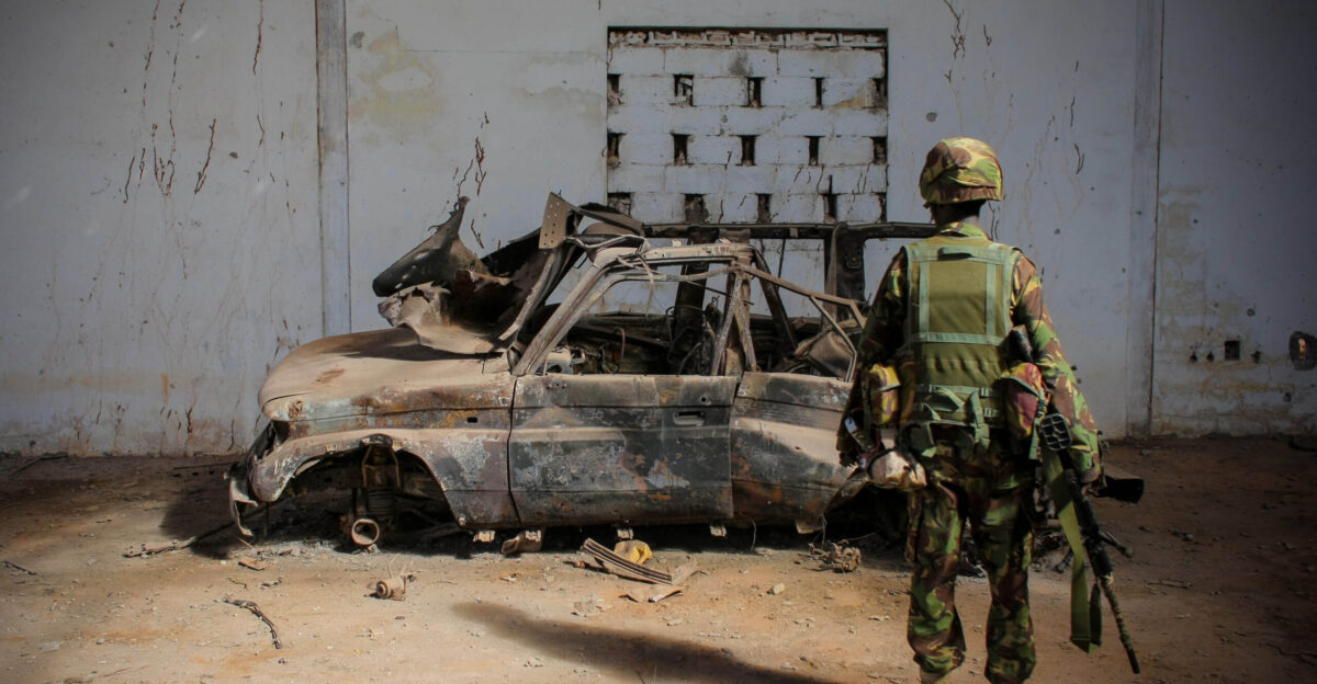 A soldier from the Kenyan Contingent of the African Union Mission in Somalia AMISOM looks at a vehicle that was destroyed a week earlier by Kenyan Air Force missile strikes inside a warehouse at Kismayo airport formly under the control of the Al-Qaeda-affilated extremist group Al Shabaab Kenyan AMISOM troops moved into and through Kismayo on 02 October 2012 the hitherto last major urban stronghold of the Al-Qaeda-affiliated extremist group Al Shabaab on their way to the city s airport without a shot being fired following a month-long operation to liberate towns and villages across southern Somalia from Afmadow to Kismayo Al Shabaab the once feared and brutal extremist group has lost a succession of strategic towns and villages across Somalia to AMISOM and Somali National Army SNA forces in sustained operations against them since they withdrew from fixed positions in the capital Mogadishu in August of 2011 AU-UN IST PHOTO STUART PRICE