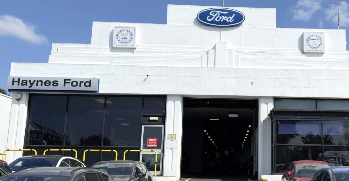 Haynes can trace its origins to 1790 when the business was founded as an ironmongery and general store in the Edgware Road, London (now the site of the Metropole Hotel). In 1832 William Haynes took the two or three-day journey to Maidstone and went into partnership with John Gurney who had acquired an ironmongery business in 1817 on the corner of Week Street and Kings Street in Maidstone, which had been known to be trading there since 1771.
<p>The Gurney and Haynes partnership continued until 1856 when John Gurney retired from the business and William Haynes bought his shares and took control. In 1857 William Haynes took into the business his eldest son, William Haynes, and traded in the name of Haynes & Son until 1863 when George Haynes, the second son, joined as a partner and it became Haynes & Sons. From the records that remain, the business expanded under the management of the father and his two sons, serving a large area of Mid and West Kent and part of East Sussex.
</p><p>The business had active workshops and specialised in amongst other things, agricultural ironmongery, heating installations, kitchen ranges and developing patents. It secured important trading connections with the rising industries in the Maidstone area – paper mills, breweries and cement works. In 1872, following the death of William Haynes, the Company changed its name to Haynes Brothers – the name of the Holding Company today. The business continued to expand and with the advent of electricity the Company set up its own electrical contracting department. Additionally, with the introduction of the 'Penny Farthing' cycle, the Company capitalised on the boom in the 1890s in the cycle market.
</p><p>Motorcycles followed and in 1903 the firm sold its first motor car – a Humber, and so the motor business was born with agencies for Daracq, DeDion, Sunbeam and the American Hupmobile. To house the expanding motor business additional premises were bought in 1906 in King Street. In 1894 the sons of George Haynes, Bernard and another William Haynes joined the Company, the third generation and two years later became a Limited company.
</p><p>In 1911 one of the most significant events in the Company’s long history took place. Bernard Haynes was taken for a demonstration ride in a Model T Ford and was so impressed with its performance up Boxley Hill together with its competitive price that he ordered one immediately at a cost of £180. From this small beginning started the firm’s long connection with Ford Motor Company as one of their main distributors, the first in Kent and the 12th in the UK. In 1922 Ronald Haynes (eldest son of Bernard) joined the Company after studying at Cambridge and training with Ford Motor Company and he played an important role in the expansion of the developing motor business. He was joined by his brother Philip in 1928 and both became Directors in 1936.
</p><p>Together they expanded the business and also bought the first 1¼ acres of the Company’s current 5 acres Ashford Road site. As times changed, the Company took the decision to focus on its motor and agricultural business acquiring a site in Parkwood, Maidstone in 1966 for its agricultural operation and body and paint division. This initiative was lead by David Haynes, son of Ronald, and then the fifth generation of the Haynes family to run the business, who joined the Company in 1953 and became Managing Director in 1966.
</p><p>Under the leadership of David Haynes, the business again expanded significantly and included the opening up of an agricultural depot in 1962 at Appledore and a further depot at Eastry in 1992. Additionally, the Company began its long association with motorsport as David Haynes, a former successful saloon car driver for the Ford Willment team, took the decision to sponsor John Taylor in his Ford Escort in the widely televised and popular rally sports series in the 1970s, and who became the first European Rally Cross Champion.
</p><p>In 2000, David Haynes’ son, Andrew Haynes, took over as Managing Director. In 2009 he took on the additional role of Chairman making him the sixth generation of the Haynes family to run the business. In 2021, to help spearhead the Company’s future growth, he took the decision to appoint the Company’s former Finance and Commercial Director, James Broadley, as Group Managing Director, with him becoming Chairman and CEO.
</p>
Since 2000 the Company has expanded significantly again and now operates with branches at Winchester, Newbury, Horsham, Uckfield, Wrotham Heath, Great Chart, Birchington and Ashford with its Head Office, Ford Transit-Centre, Accident Repair Centre and a new upgraded FordStore showroom situated on an expanded 5-acre site at Ashford Road in Maidstone. Today its major franchises include Ford, Iveco, New Holland, Case IH, JCB & Fiat Professional Commercials and with a staff of just under 340 the Company has sales in excess of £100 million