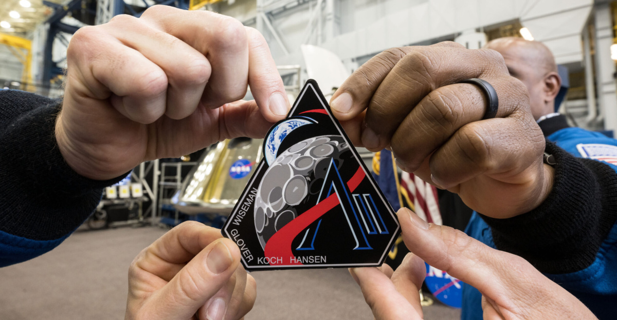 jsc2025e034746 (April 2, 2025) -- Artemis II crew with the Artemis II mission patch. Photo Credit: NASA/Robert Markowitz