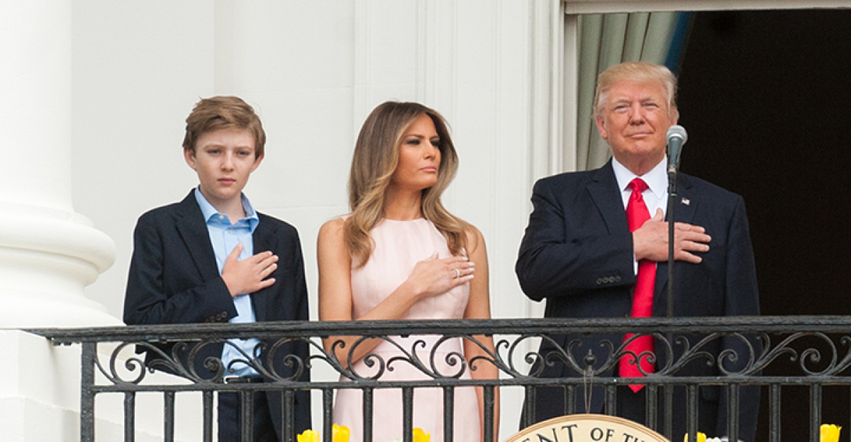 President Donald Trump, First Lady Melania Trump, and their son, Barron Trump, have their hands over their hearts while “The President's Own” U.S. Marine Band performs the National Anthem, Monday, April 17, 2017, kicking off the 139th Easter Egg Roll at the White House. This was the first Easter Egg Roll of the Trump Administration. (Official White House Photo by Joyce Boghosian)