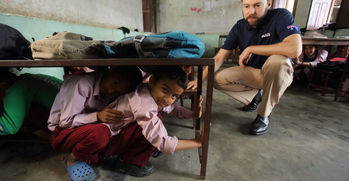 Students practice earthquake drill Jana Bikash Secondary School Matatirtha is in the process of being redeveloped to make the school more earthquake proof As part of this process children are taught how to take shelter beneath their desks in case of an earthquake Photo by Jim Holmes for AusAID 13 2529