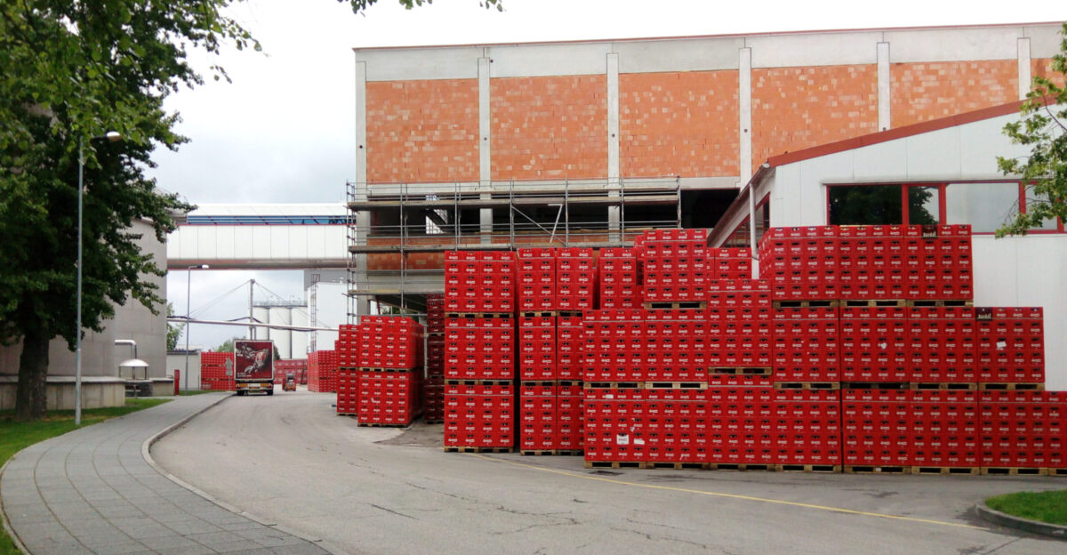 Beer crates in Bud jovick Budvar a brewery in esk Bud jovice South Bohemian Region Czechia with the new filling plant under construction at the back