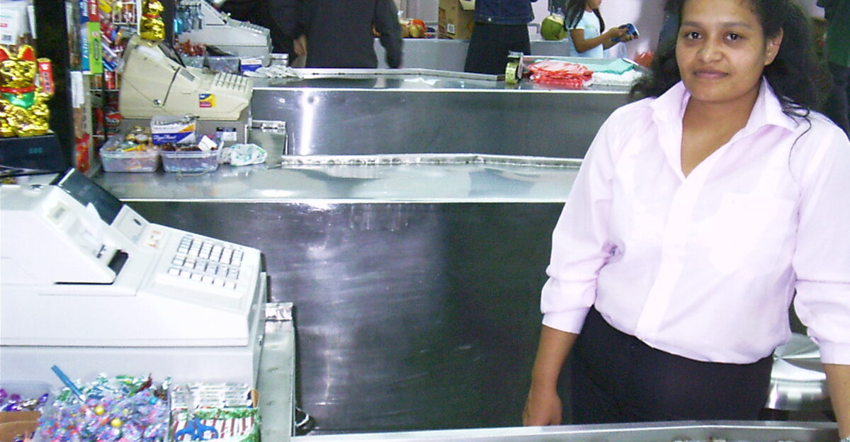 A w cashier at her register in a grocery store in Panama