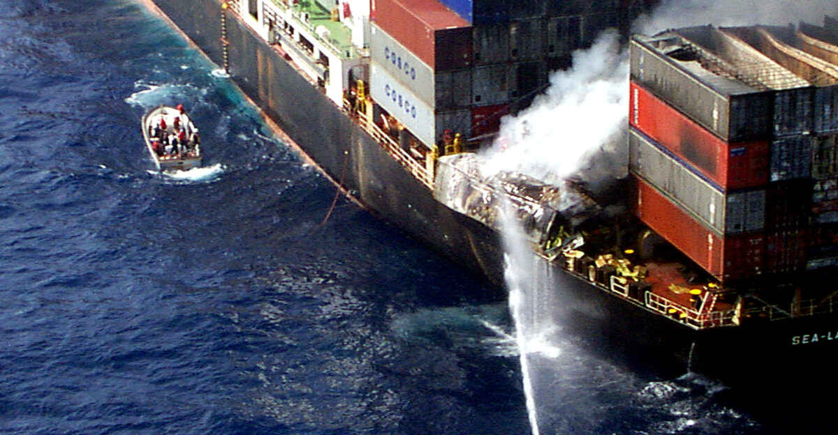 Sailors from the U S Navy amphibious assault ship USS Wasp LHD 1 aim a fire hose at burning cargo containers aboard the merchant cargo vessel Sea Land Mariner in the Mediterranean Sea on April 18 1998 Search and rescue crew members helicopters and an 18-person fire-fighting team from the Wasp responded to an emergency distress call from the merchant vessel in the Mediterranean Sea approximately 85 miles west of Crete A U S Navy CH-46 Sea Knight helicopter air-lifted two of the merchant vessel crew members to the Wasp for medical treatment of injuries caused by the initial explosion