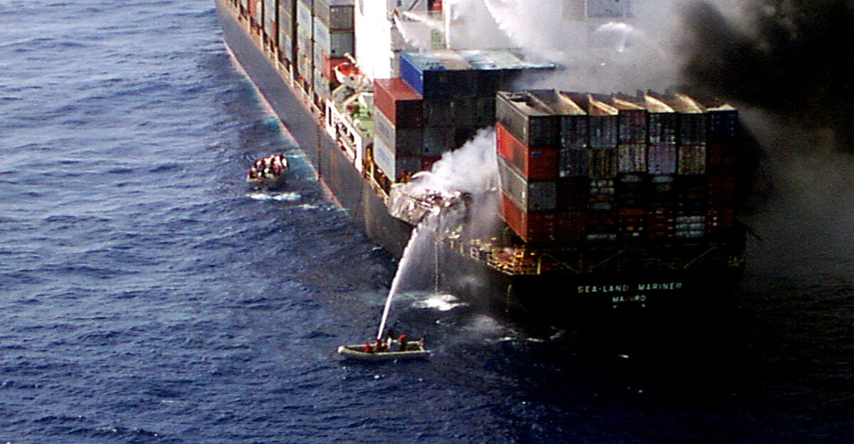 Sailors from the U S Navy amphibious assault ship USS Wasp LHD 1 aim a fire hose at burning cargo containers aboard the merchant cargo vessel Sea Land Mariner in the Mediterranean Sea on April 18 1998 Search and rescue crew members helicopters and an 18-person fire-fighting team from the Wasp responded to an emergency distress call from the merchant vessel in the Mediterranean Sea approximately 85 miles west of Crete A U S Navy CH-46 Sea Knight helicopter air-lifted two of the merchant vessel crew members to the Wasp for medical treatment of injuries caused by the initial explosion