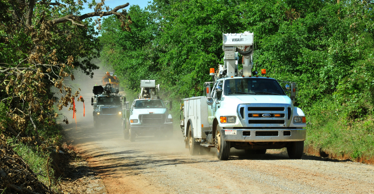 Cleveland County, OK, May 20, 2010 -- An Oklahoma Electrical Cooperative line crew travels down a rural road on its way to repair electrical infrastructure in a section of the county struck by a tornado on May 10. The eastern half of the state was affected by 22 confirmed tornadoes that day.  FEMA Photo by Win Henderson