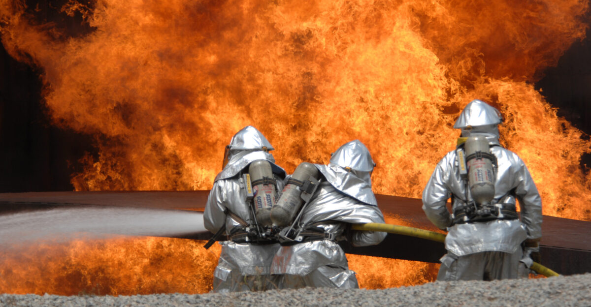 United States Air Force Airmen from the 20th Civil Engineer Squadron Fire Protection Flight neutralize a live fire during a field training exercise at Shaw Air Force Base in South Carolina May 23 2007 The exercise includes training in self-aid buddy care expedient firefighting weapons handling and night-vision devices