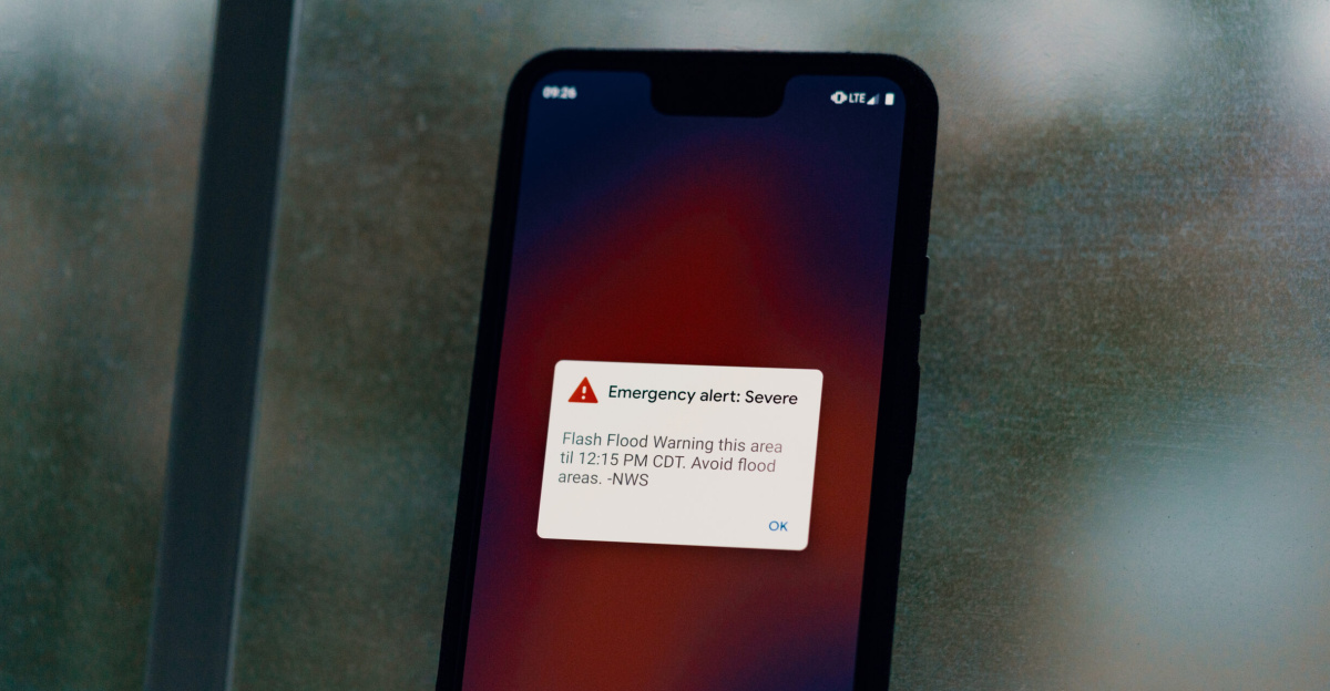 An emergency weather alert from the National Weather Service warns of a flash flood warning on an Android Pixel 3 XL smartphone, during a thunderstorm in Austin, Texas: "Emergency alert: Severe - Flash Flood Warning this area til 12:15 PM CDT. Avoid flood areas. -NWS"