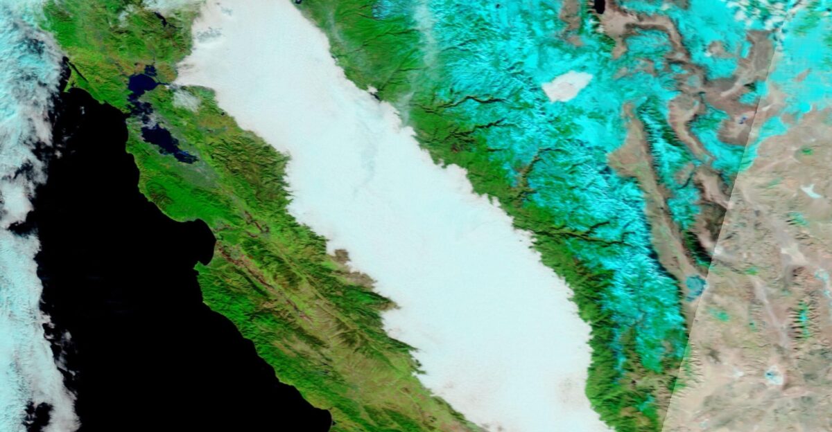 Thick fog frequently fills California s Central Valley in late fall and winter often creating a risk for drivers as visibility plummets The Moderate Resolution Imaging Spectroradiometer MODIS on board NASA s Terra satellite acquired a false-color image of a huge bank of fog on December 15 In this type of false-color image infrared and visible light MODIS Bands 7 2 1 are combined to help separate snow which appears electric blue from cloud and fog Fog and most clouds look bright white although high cold clouds which contain ice crystals may be tinted with electric blue Vegetation appears green open land looks tan while water shows up as inky-black The formation of fog requires three ingredients wet ground still air and cold temperatures Conditions are ripe after the ground has become damp from a recent rain During the day the warmth of the Sun causes the moisture to evaporate into the air After sunset air temperature slowly drops Because cool air can hold less moisture than warm air the many tiny moisture droplets suspended in the air during the day combine into large droplets creating low cloud or fog The Central Valley winter fog also called Tule too-le tends to form-often rapidly- after sunset become thickest just before dawn then slowly thins as air warms in the morning Tule fog season typically begins in December and ends in February
