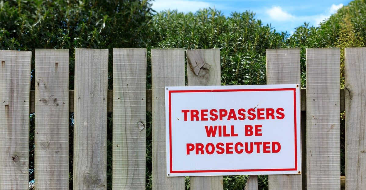 fence wooden fence wood boards sign trespassing trespassers trespassing trespassing trespassing trespassing trespassing