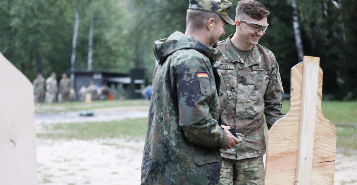 German Bundeswehr 1st Lt Stephen Schmidt Panzerbataillon 104 Panzerbrigade 12 and Spc Bryce Dorvall Lightning Troop 3rd Squadron 2d Cavalry Regiment assess Dorvall s accuracy after firing the 9mm pistol during the German Armed Forces Proficiency Badge qualification at the Grafenwoehr Training Area Germany August 12 2019 The GAFPB is an approved foreign service award and one of the most sought after amongst U S Soldiers U S Army photo by 1st Lt Ellen C Brabo 2d Cavalry Regiment