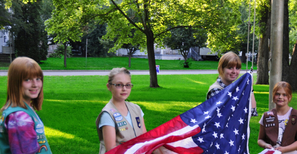 Girl Scouts raising the American flag Owen Park in Eau Claire Wisconsin at a Municipal Band concert Previously published picasa