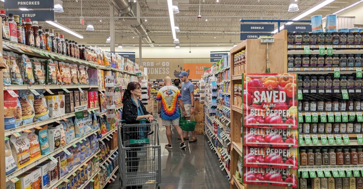Woman browsing groceries inside a Sprouts