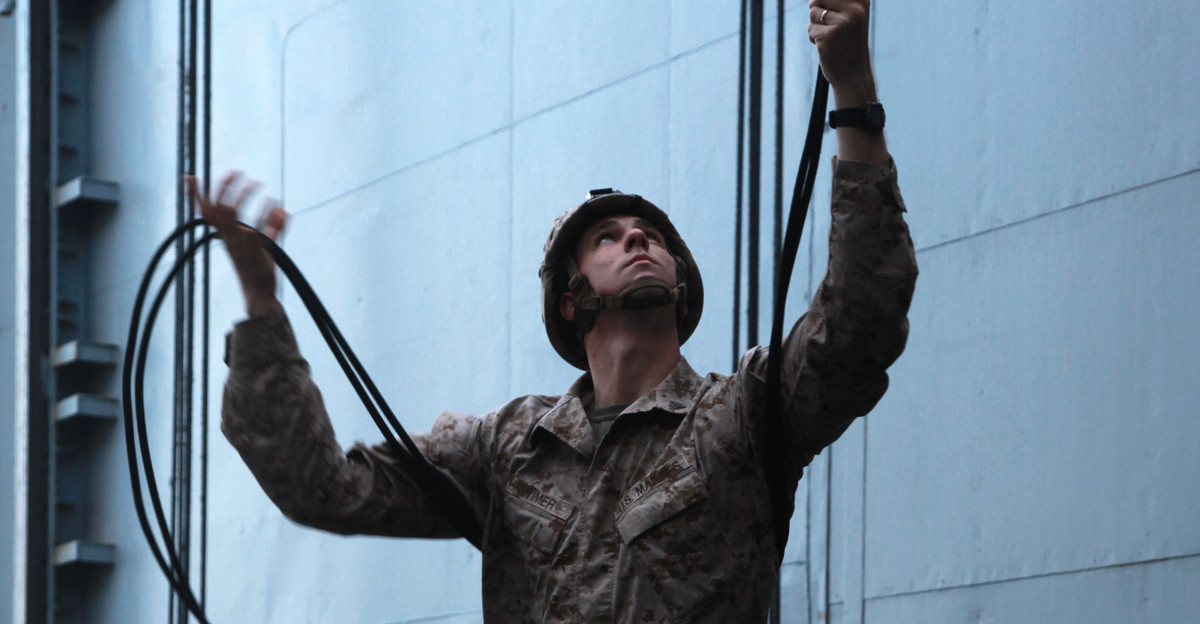 Sergeant Stephen D Wimer machine gun section leader Weapons Platoon Kilo Company Battalion Landing Team 3 5 15th Marine Expeditionary Unit collects extra rope during rappelling training off the flight deck of USS Peleliu March 5 The main training objective was keeping the 14 BLT Helicopter Rope Suspension Technique masters current in their qualifications but it also gave the Security Platoon an opportunity to practice rappelling which is one of the ways troops can be inserted into different situations The 15th MEU is deployed as part of the Peleliu Amphibious Ready Group as a U S Central Command theater reserve force providing support for maritime security operations and theater security cooperation efforts in the U S 5th Fleet area of responsibility Wimer 25 is from Romeo Mich and is a HRST master with the unit U S Marine Corps photo by Cpl John Robbart III