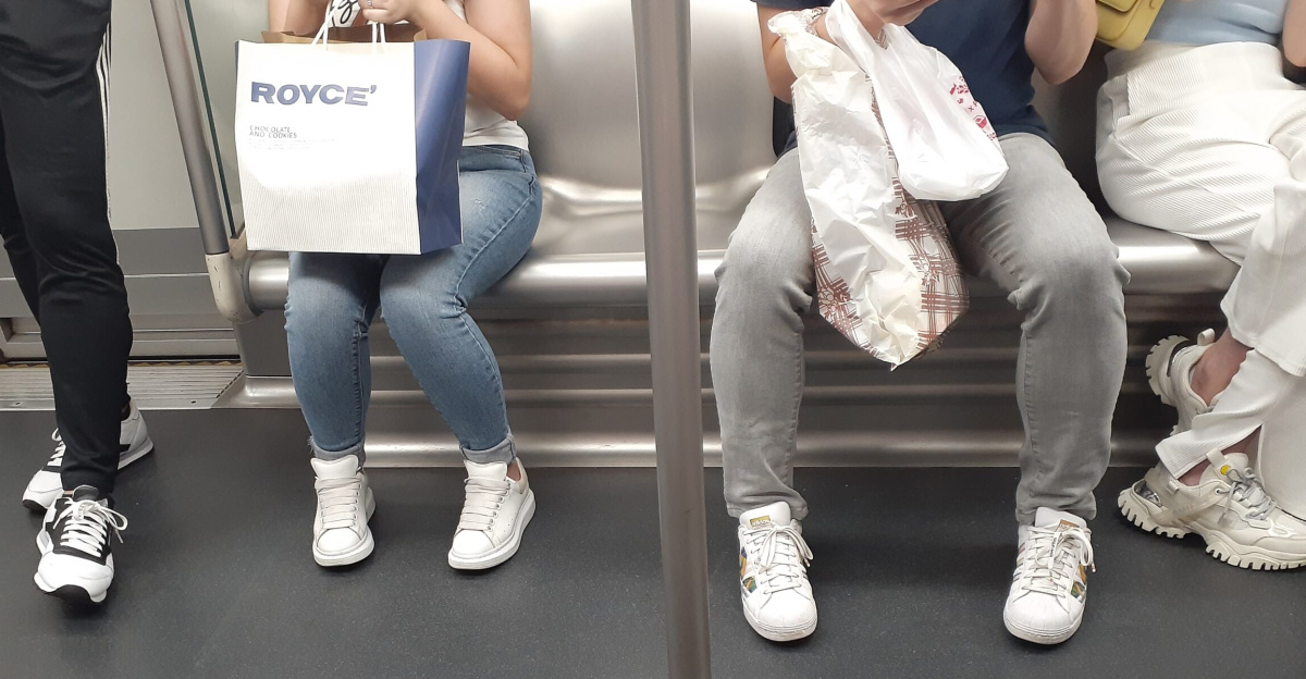 HK MTR train interior visitors jeans pants blue white grey black n sports shoes paper bag Royce' Chocolate and Cakes inAugust 2021