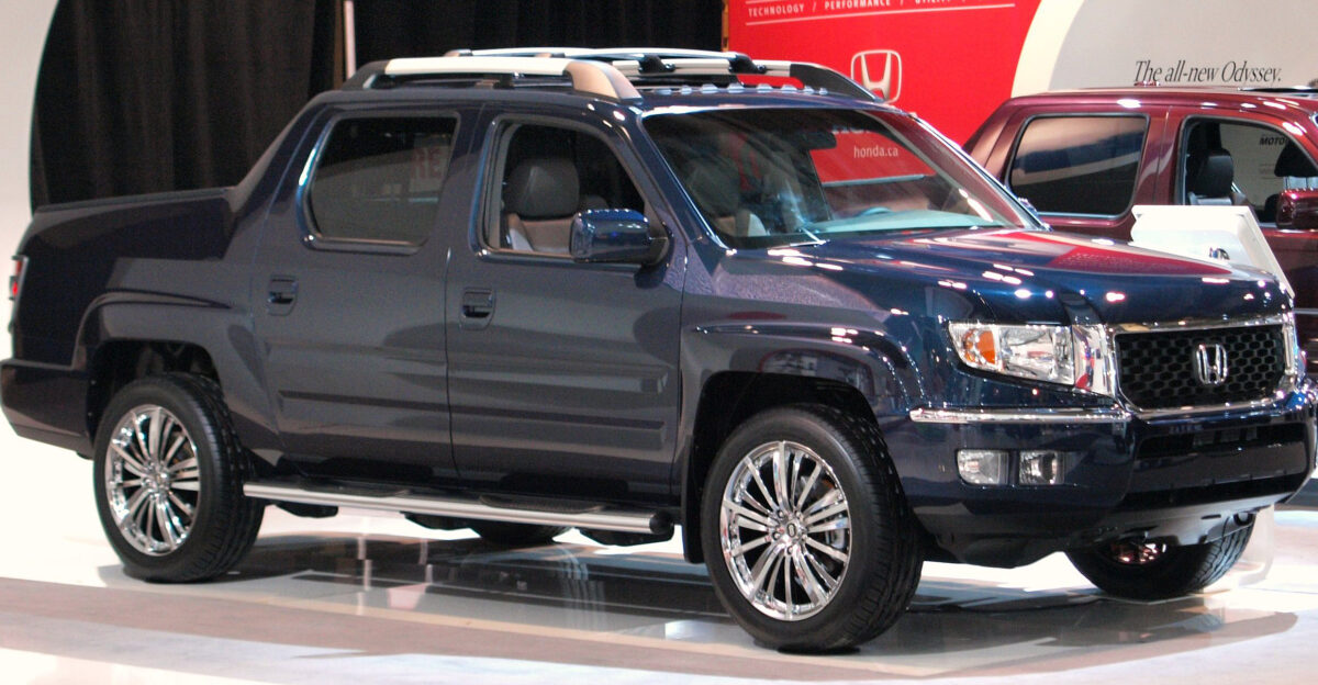 Honda Ridgeline RTL with OEM optional sport grill chrome bumper trim chrome side steps body side protectors taillight garnish and roof rack On display with custom aftermarket chrome wheels