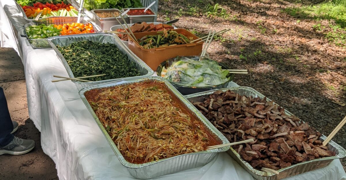 Potluck of Korean barbecued meat banchan and vegetables