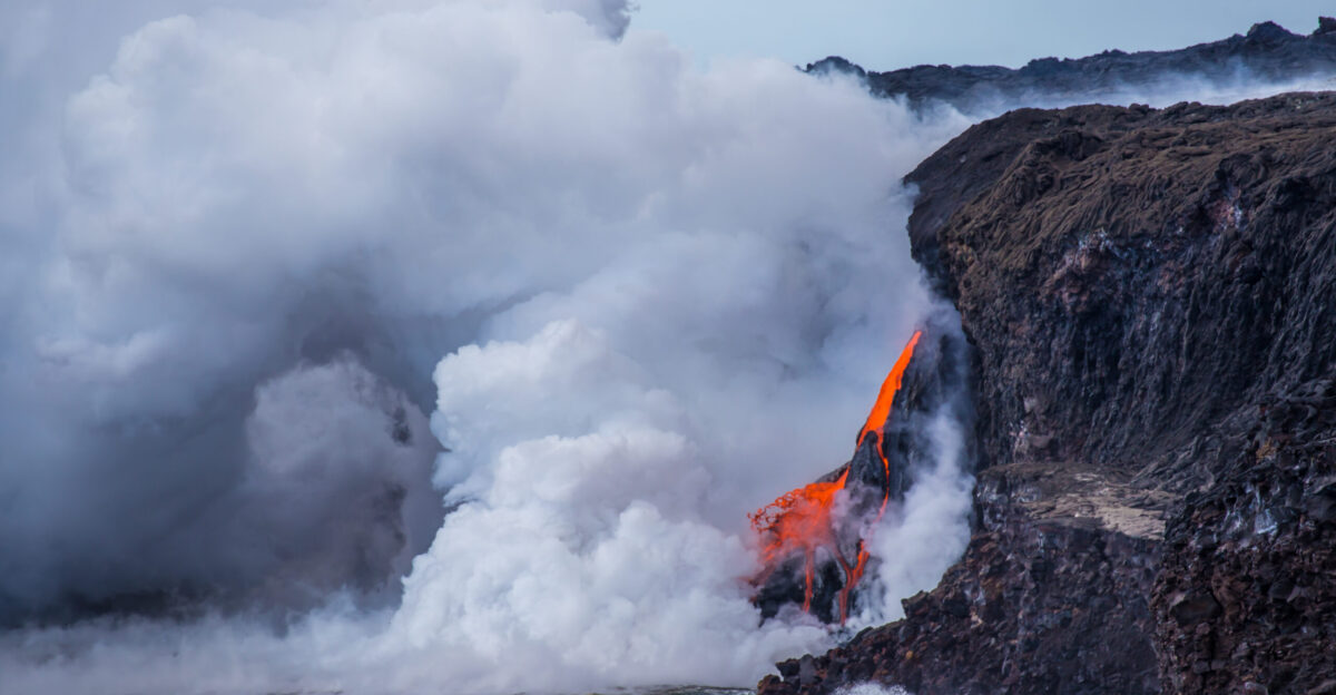 Lava cascades down a sea cliff into the ocean at Kamokuna 1 2 17