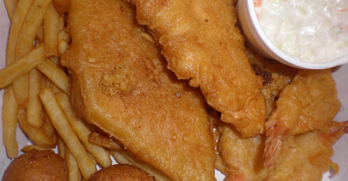 A Long John Silver s Sampler consisting of 1 piece of fish 3 shrimp 1 chicken plank coleslaw fries and 2 hushpuppies