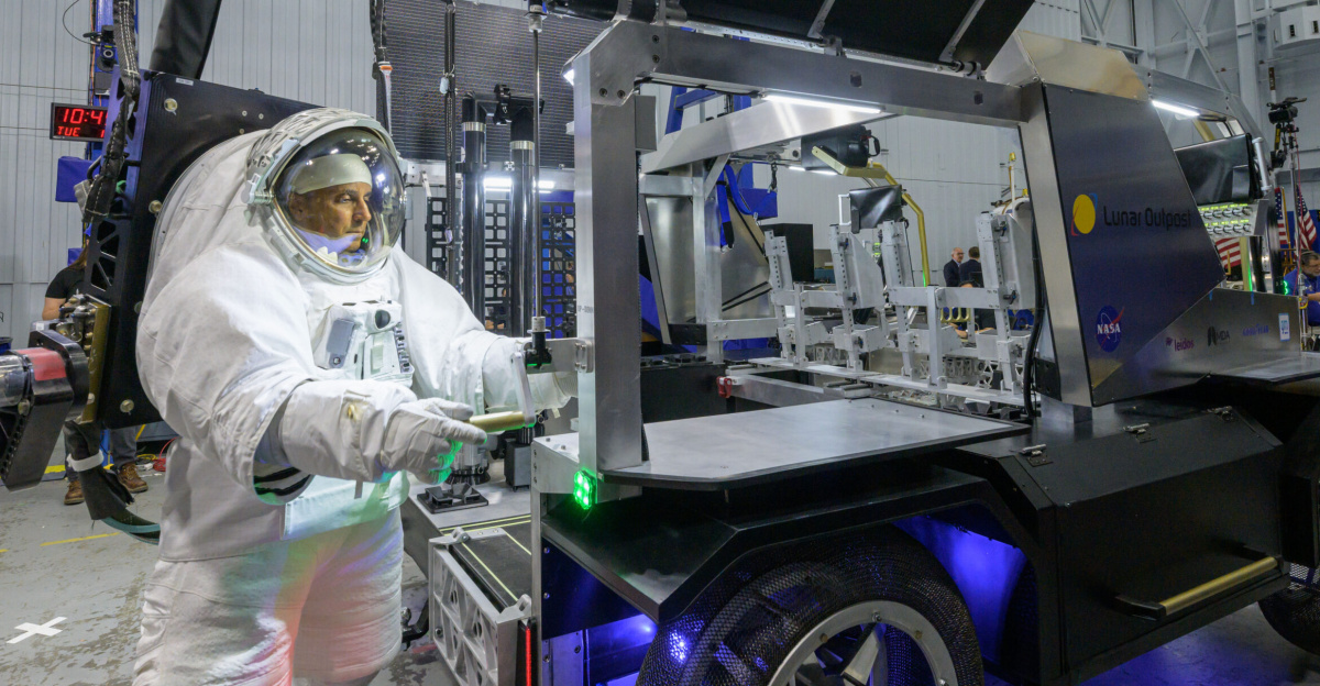 NASA astronaut Joe Acaba raises the solar array panel on Lunar Outpost’s Eagle lunar terrain vehicle during testing at NASA’s Johnson Space Center. Image Credit: NASA/Robert Markowitz