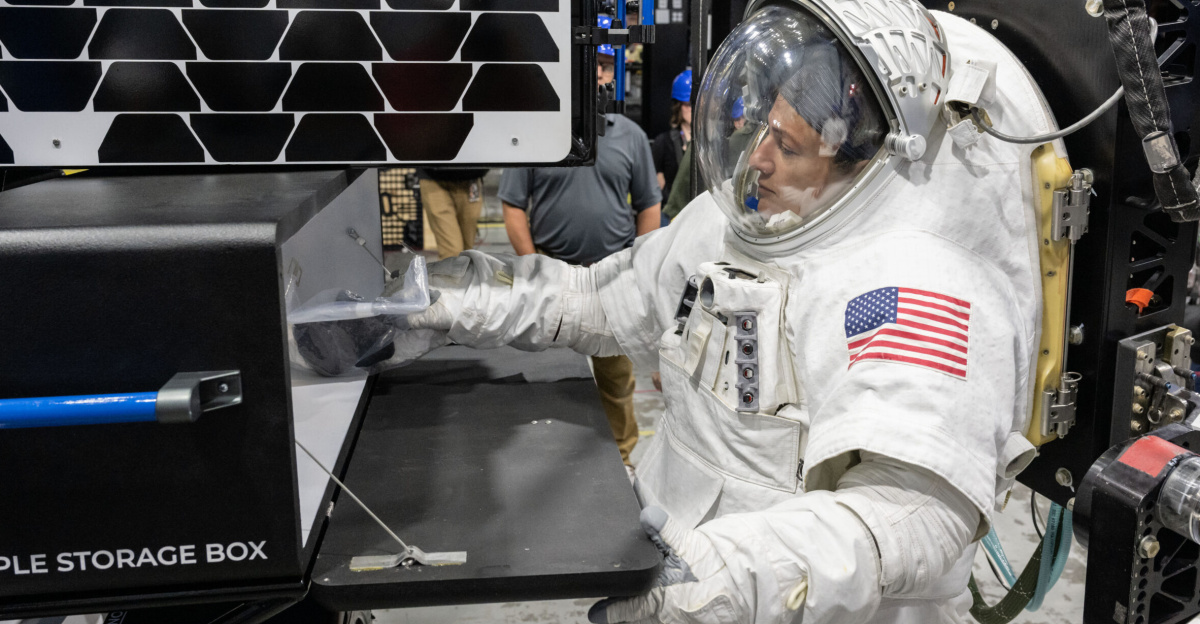 NASA astronaut Jessica Meir puts a science sample inside of a storage box on Intuitive Machines’ Moon RACER lunar terrain vehicle during testing at NASA’s Johnson Space Center. Image Credit: NASA/James Blair