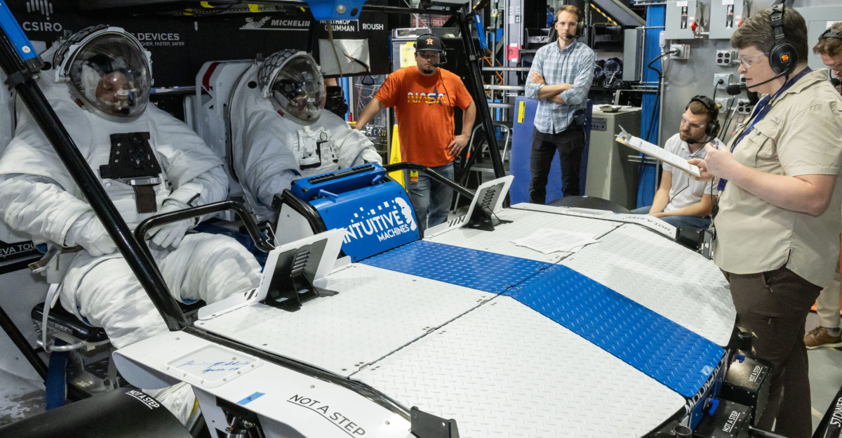 NASA engineer Dave Coan (left) and NASA astronaut Jessica Watkins (right) sit inside Intuitive Machines’ Moon RACER lunar terrain vehicle evaluating the crew compartment during testing at NASA’s Johnson Space Center. Image Credit: NASA/James Blair