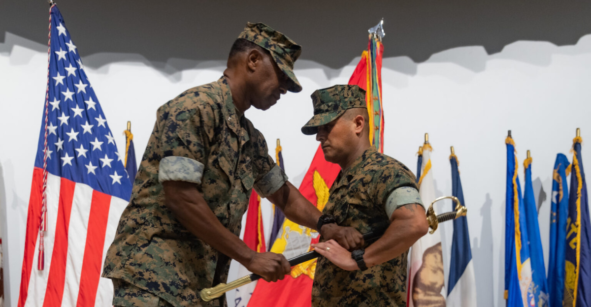 U.S. Marine Corps Lt. Col. Calischaran James, left, commanding officer of Marine Aviation Logistics Squadron (MALS) 36, Marine Aircraft Group (MAG) 36, 1st Marine Aircraft Wing, passes a noncommissioned officer sword to Sgt. Maj. Enrique De Anda, incoming sergeant major of MALS-36, on Marine Corps Air Station Futenma, Okinawa, Japan, Aug. 26, 2025. During the ceremony, Sgt. Maj. De Anda was appointed as the sergeant major of MALS-36. (U.S. Marine Corps photo by Lance Cpl. Carlos Paz-Sosa)