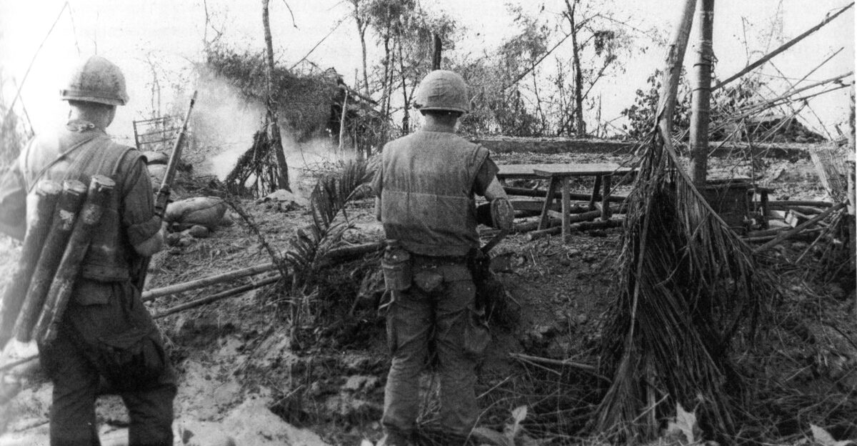U S Marines move through the ruins of the hamlet of Dai Do after several days of intense fighting during the Tet Offensive