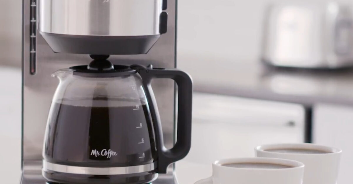 A Mr Coffee machine beside two coffee mugs